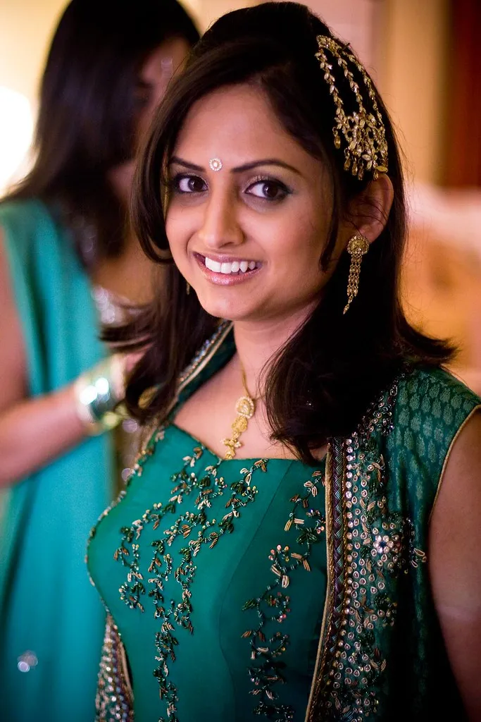 Side profile bridal makeup with statement necklace and elegant hairstyle